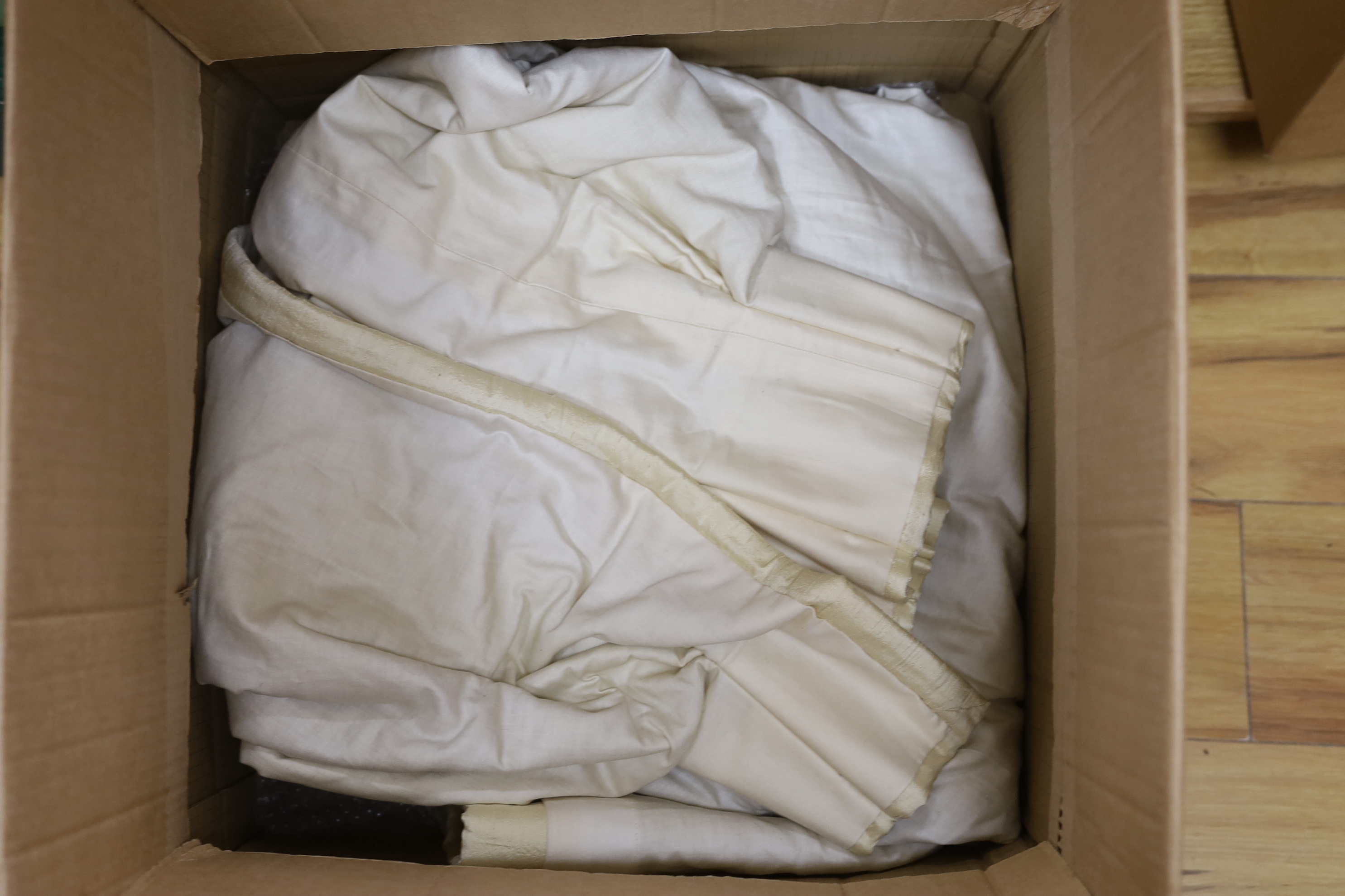 A pair of ivory coloured silk curtains, 137cm high